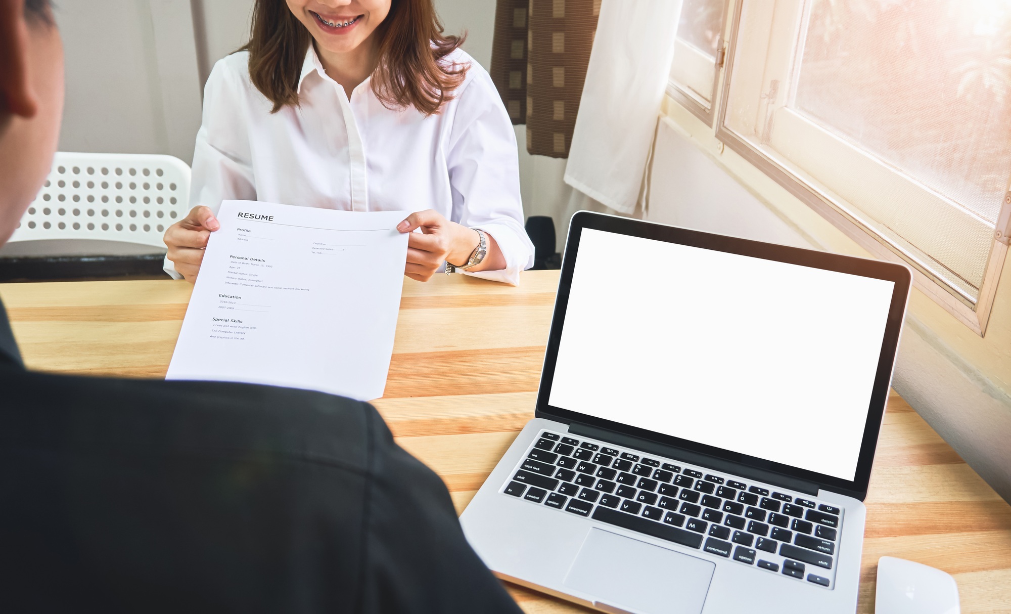 Young woman submit resume to employer to review job application.